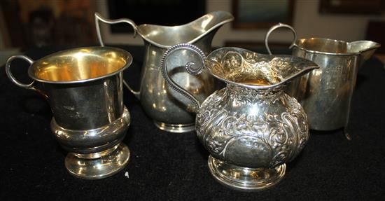 .3 silver cream jugs and a mug